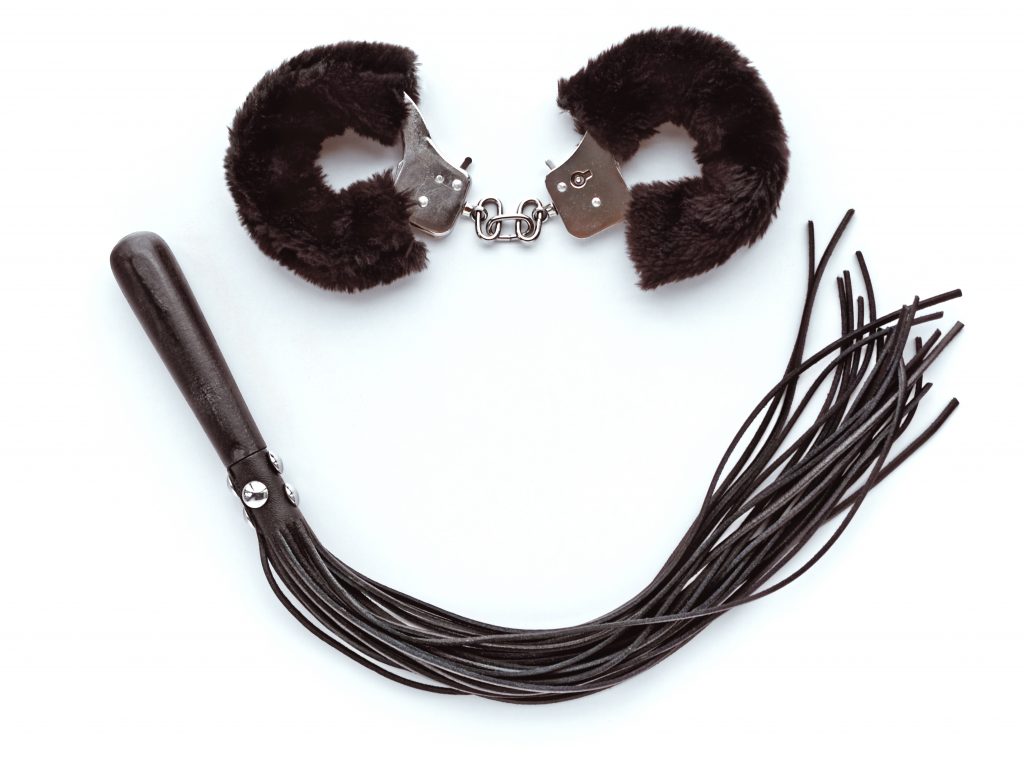 fuzzy handcuffs and flogger